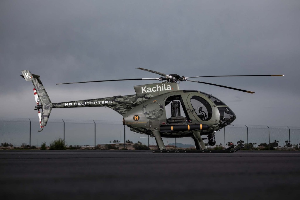 Camouflage helicopter carrying Kachila and Hercules Dynamics branding